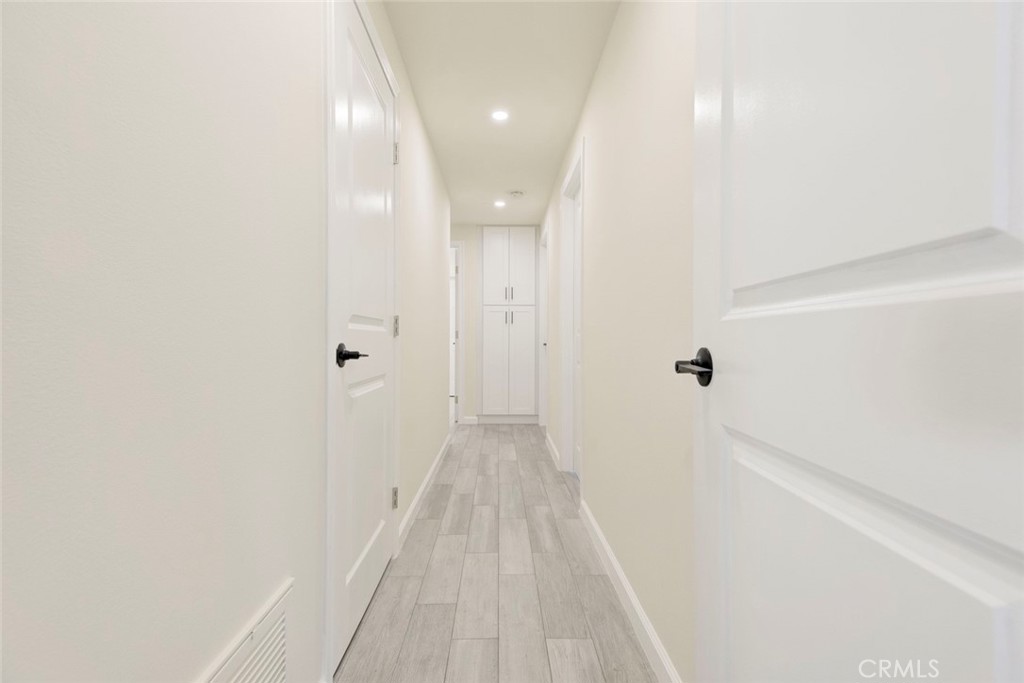 11369 Darby Avenue Porter Ranch, CA 91326 - Photo 21 of 56 a view of a hallway with wooden floor
