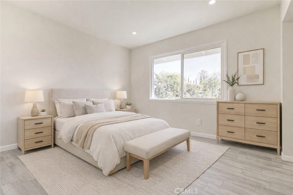 11369 Darby Avenue Porter Ranch, CA 91326 - Photo 22 of 56 a spacious bedroom with a bed and a window