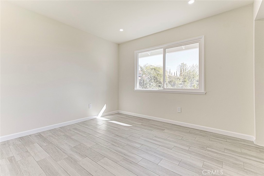 11369 Darby Avenue Porter Ranch, CA 91326 - Photo 23 of 56 an empty room with wooden floor and windows
