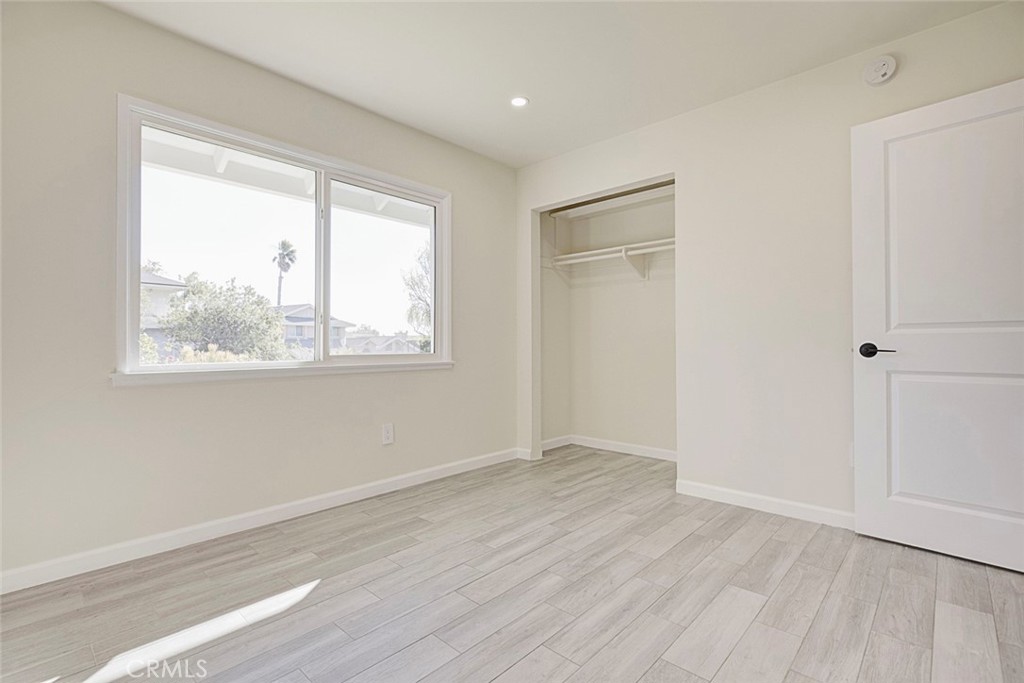 11369 Darby Avenue Porter Ranch, CA 91326 - Photo 24 of 56 an empty room with wooden floor and windows