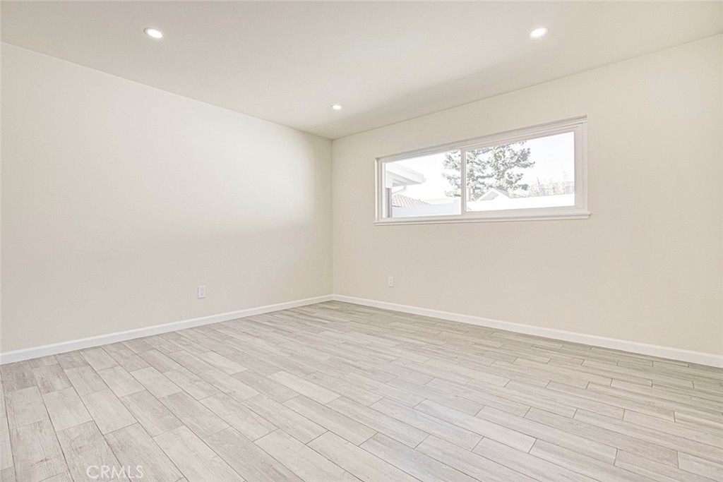 11369 Darby Avenue Porter Ranch, CA 91326 - Photo 28 of 56 an empty room with wooden floor and windows