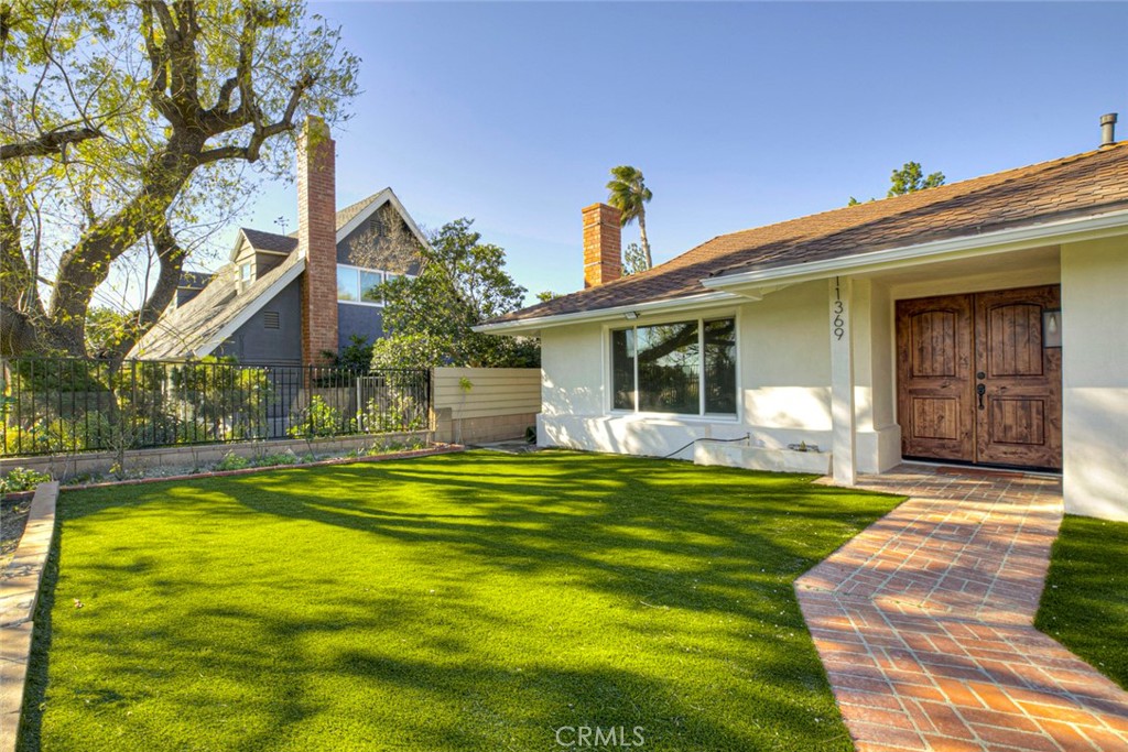 11369 Darby Avenue Porter Ranch, CA 91326 - Photo 3 of 56 a front view of a house with swimming pool