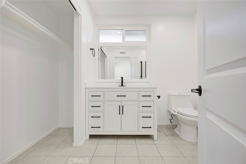 11369 Darby Avenue Porter Ranch, CA 91326 - Photo 31 of 56 a bathroom with a sink a toilet and mirror