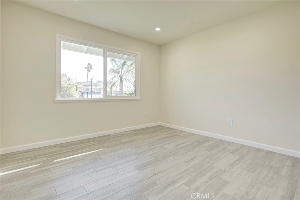 11369 Darby Avenue Porter Ranch, CA 91326 - Photo 34 of 56 an empty room with wooden floor and windows