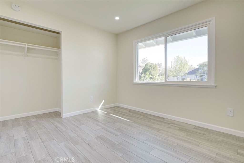 11369 Darby Avenue Porter Ranch, CA 91326 - Photo 35 of 56 an empty room with wooden floor and windows