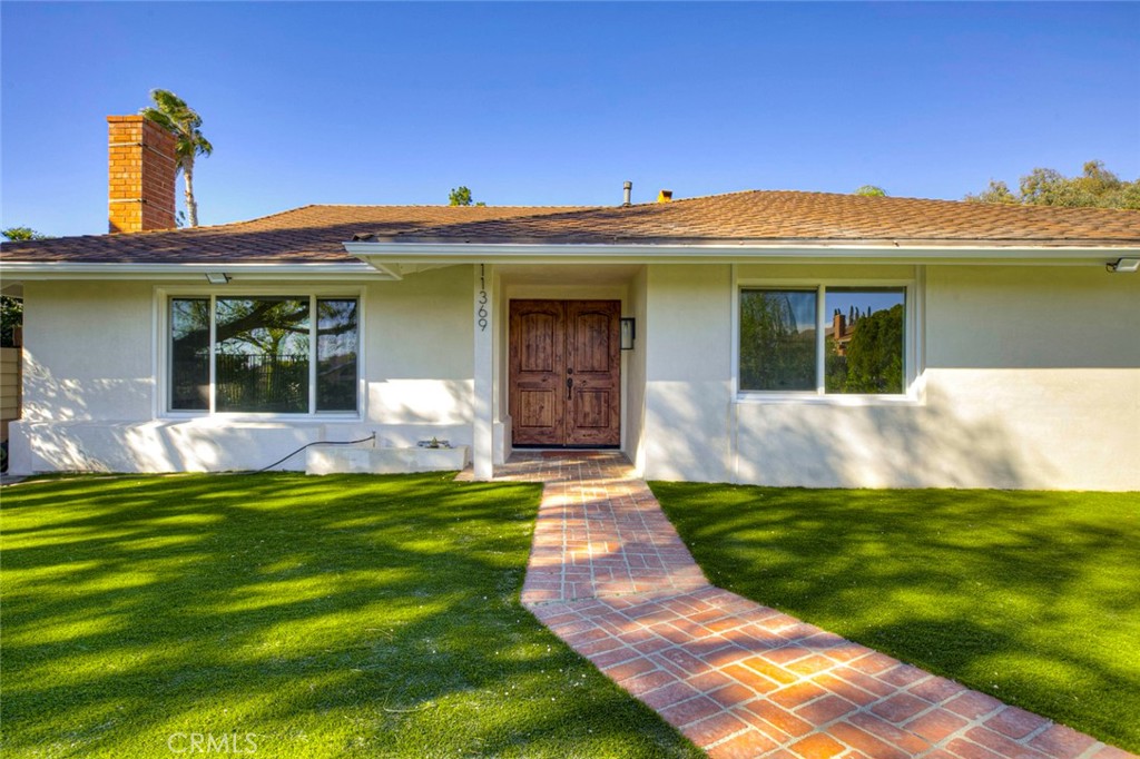 11369 Darby Avenue Porter Ranch, CA 91326 - Photo 4 of 56 a view of a house with a yard potted plants and a table