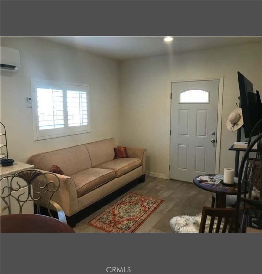 11369 Darby Avenue Porter Ranch, CA 91326 - Photo 53 of 56 a living room with furniture and a flat screen tv