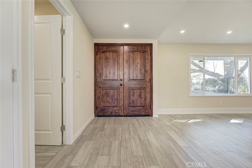 11369 Darby Avenue Porter Ranch, CA 91326 - Photo 7 of 56 an empty room with wooden floor and windows