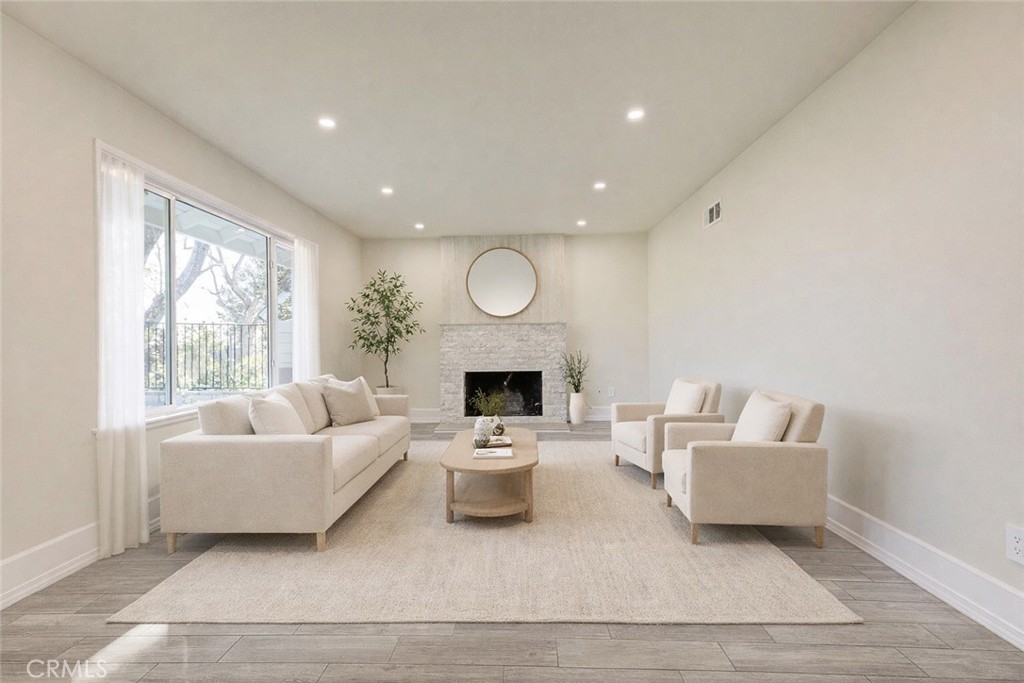 11369 Darby Avenue Porter Ranch, CA 91326 - Photo 9 of 56 a living room with furniture and a fireplace