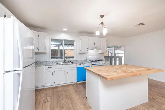 a kitchen with a stove a sink and a refrigerator