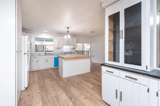 a kitchen with granite countertop cabinets stainless steel appliances and a counter space