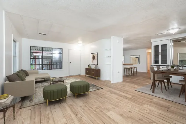 a living room with furniture and a wooden floor
