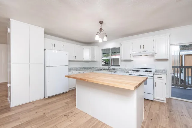 a view of a kitchen wooden floor and a window