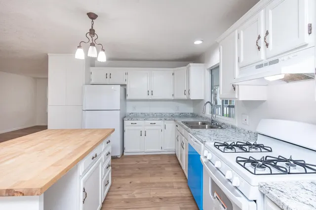 an empty room with wooden floor and closet