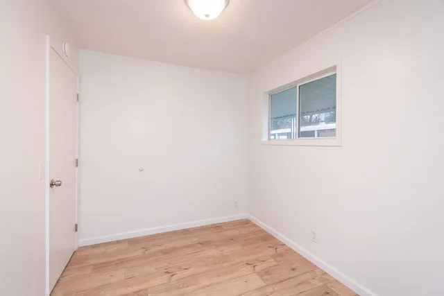 a view of a house with a yard and a large tree