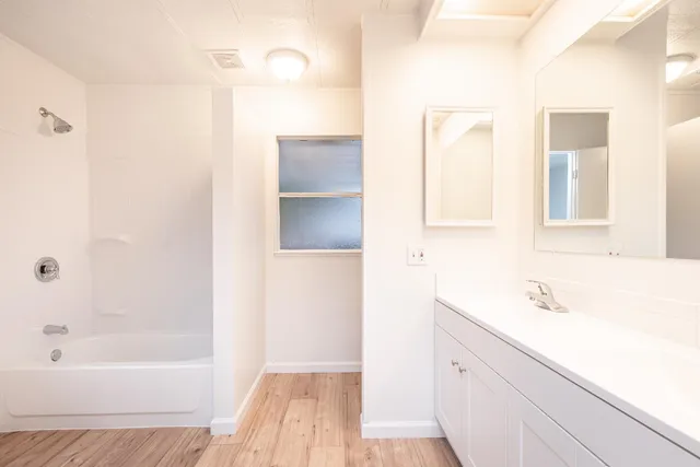 an aerial view of residential houses with outdoor space and ocean view