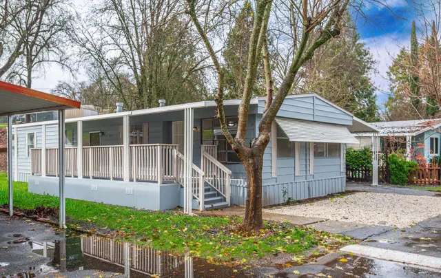 a front view of a house with a garden