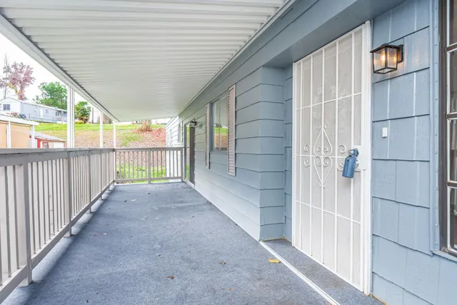 a view of a room with wooden floor and white walls