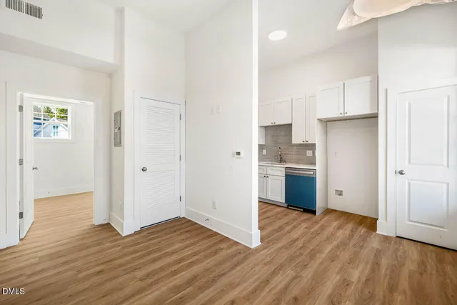 a view of kitchen with wooden floor electronic appliances and window