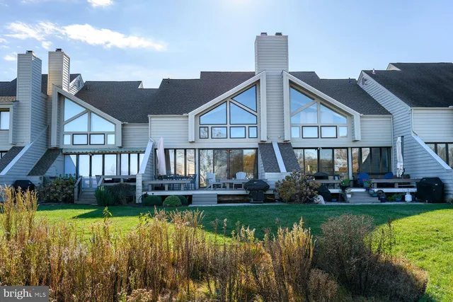 a front view of a house with a yard table and chairs