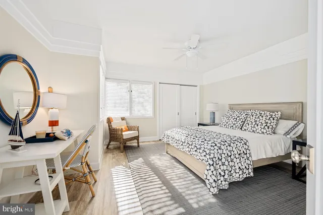 a bedroom with a bed a couch and dresser