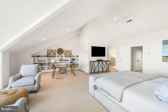 a bedroom with furniture and a flat screen tv