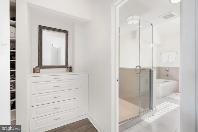 a bathroom with a shower sink and mirror