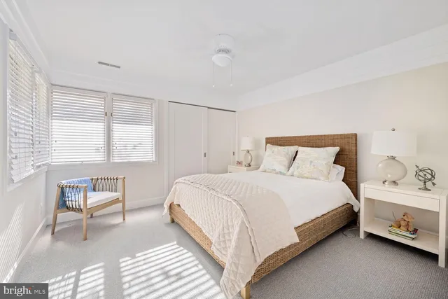 a bedroom with a bed and a chair