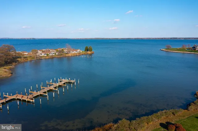 an aerial view of a houses with a lake view