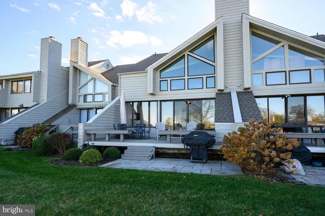 a front view of a house with a garden and patio