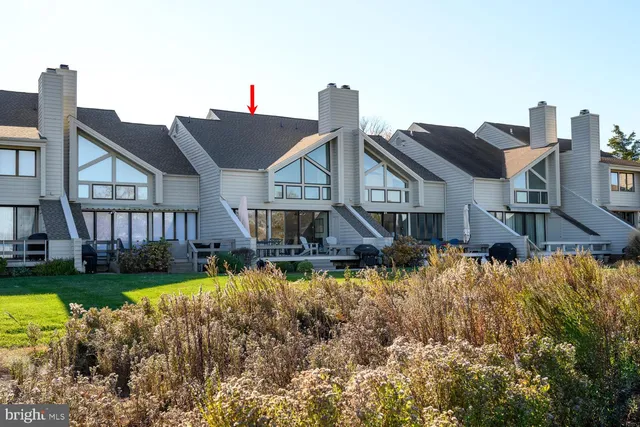 a front view of a house with swimming pool having outdoor seating