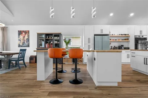 a living room with stainless steel appliances kitchen island granite countertop furniture and a kitchen view