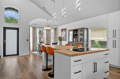 a kitchen with stainless steel appliances granite countertop a stove and a wooden floors