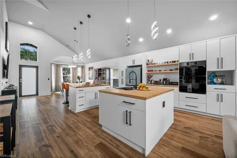 a kitchen with cabinets and wooden floor