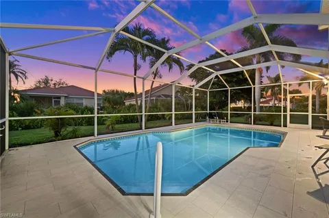 a view of a backyard with a patio and a yard