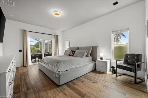 a bedroom with a bed and a large window