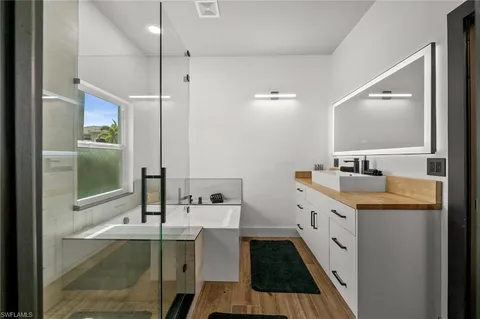 a bathroom with a sink double vanity and shower