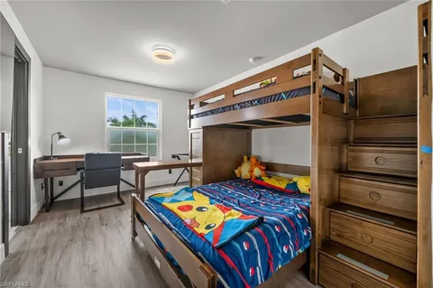 a bed room with a bed and a flat screen tv