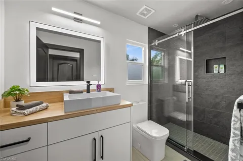 a view of a room that has a bed and a table in it