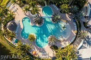 a view of a swimming pool with outdoor seating