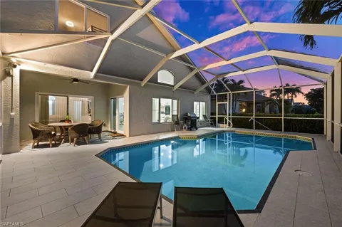 a view of a swimming pool with sitting area