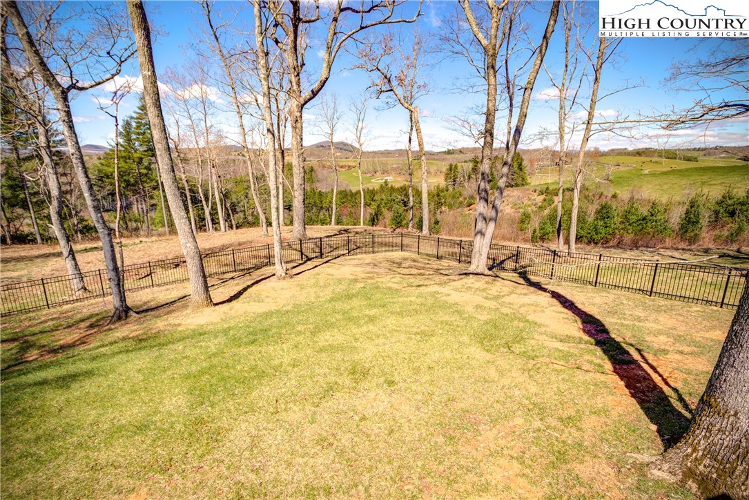397 Turtle Ridge Road Sparta, NC 28675 - Photo 14 of 33 a swimming pool with outdoor seating and yard