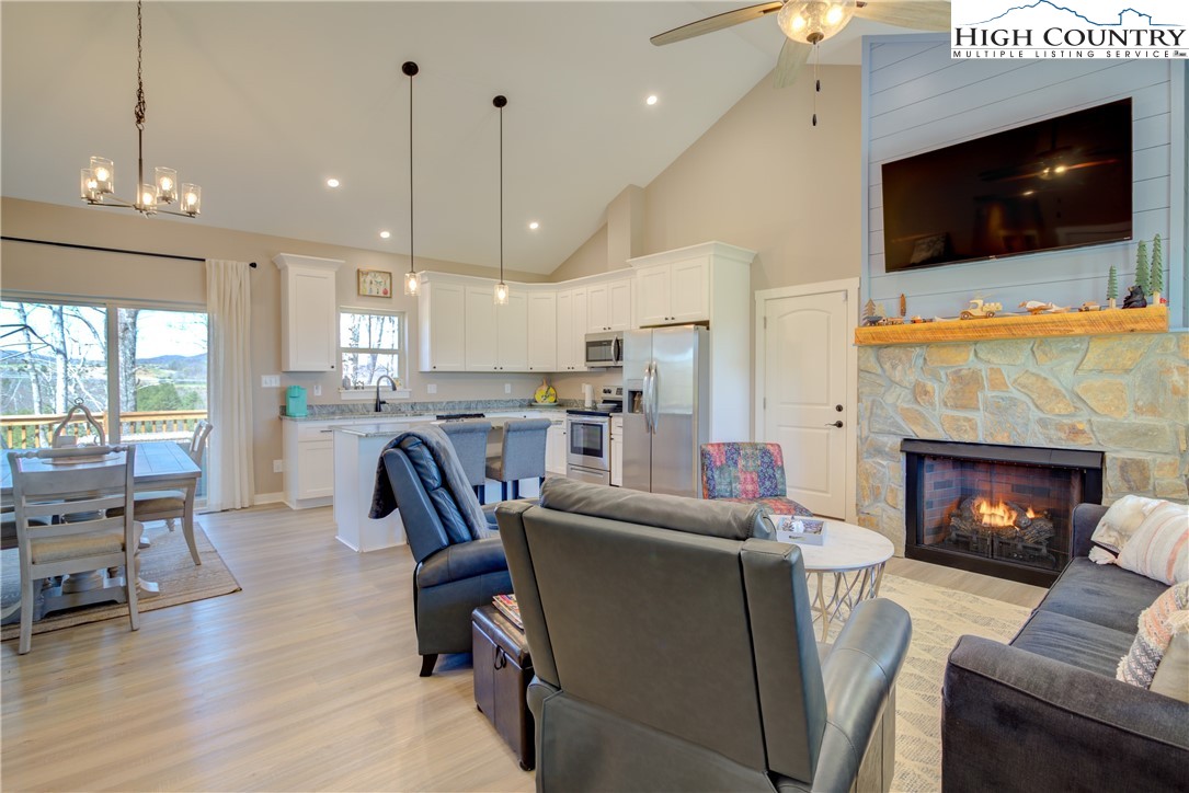 397 Turtle Ridge Road Sparta, NC 28675 - Photo 15 of 33 a living room with furniture a flat screen tv and a fireplace