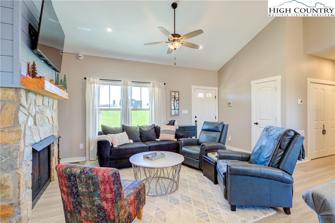 397 Turtle Ridge Road Sparta, NC 28675 - Photo 16 of 33 a living room with fireplace furniture and a flat screen tv