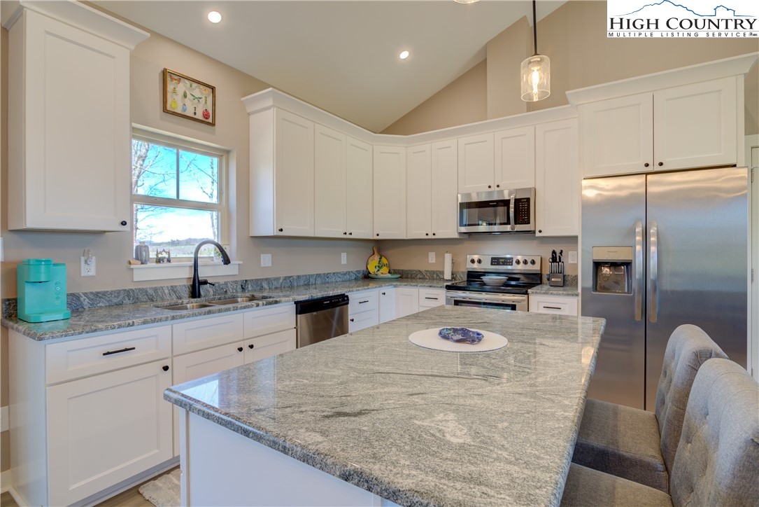 397 Turtle Ridge Road Sparta, NC 28675 - Photo 20 of 33 a kitchen with granite countertop a refrigerator stove top oven and sink