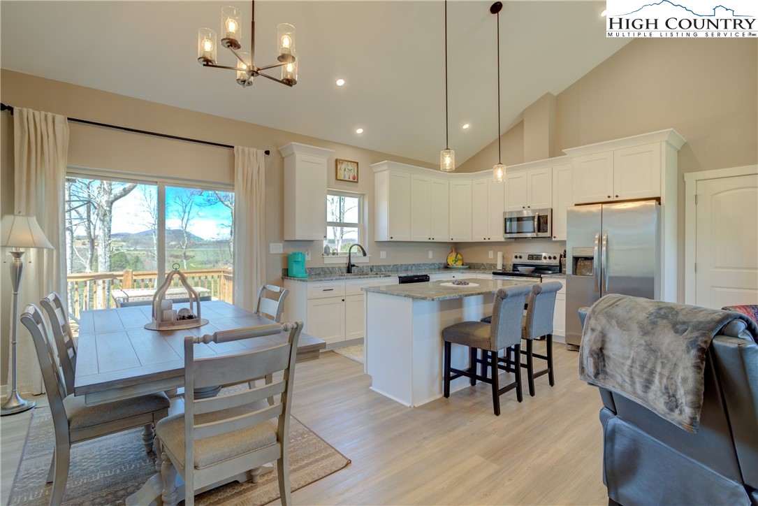 397 Turtle Ridge Road Sparta, NC 28675 - Photo 23 of 33 a kitchen with a dining table chairs appliances and cabinets