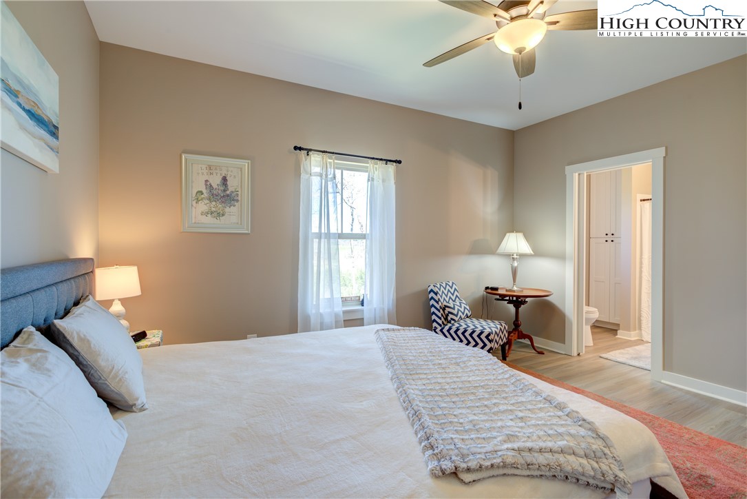 397 Turtle Ridge Road Sparta, NC 28675 - Photo 27 of 33 a bedroom with bed and a chandelier