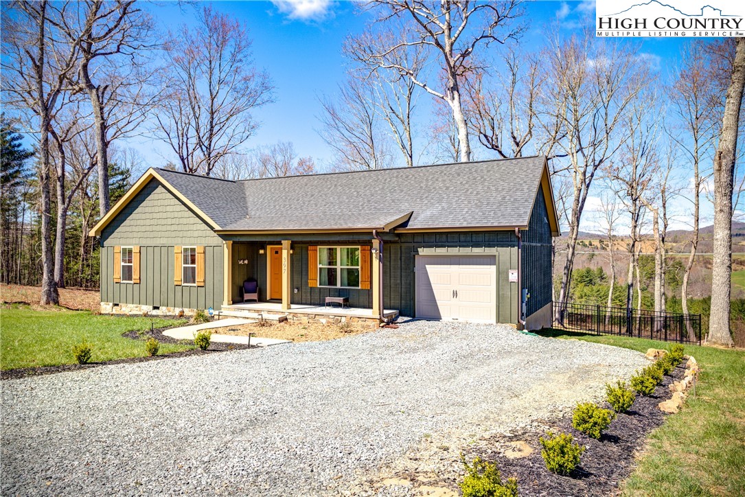 397 Turtle Ridge Road Sparta, NC 28675 - Photo 3 of 33 a front view of a house with a yard covered with green space