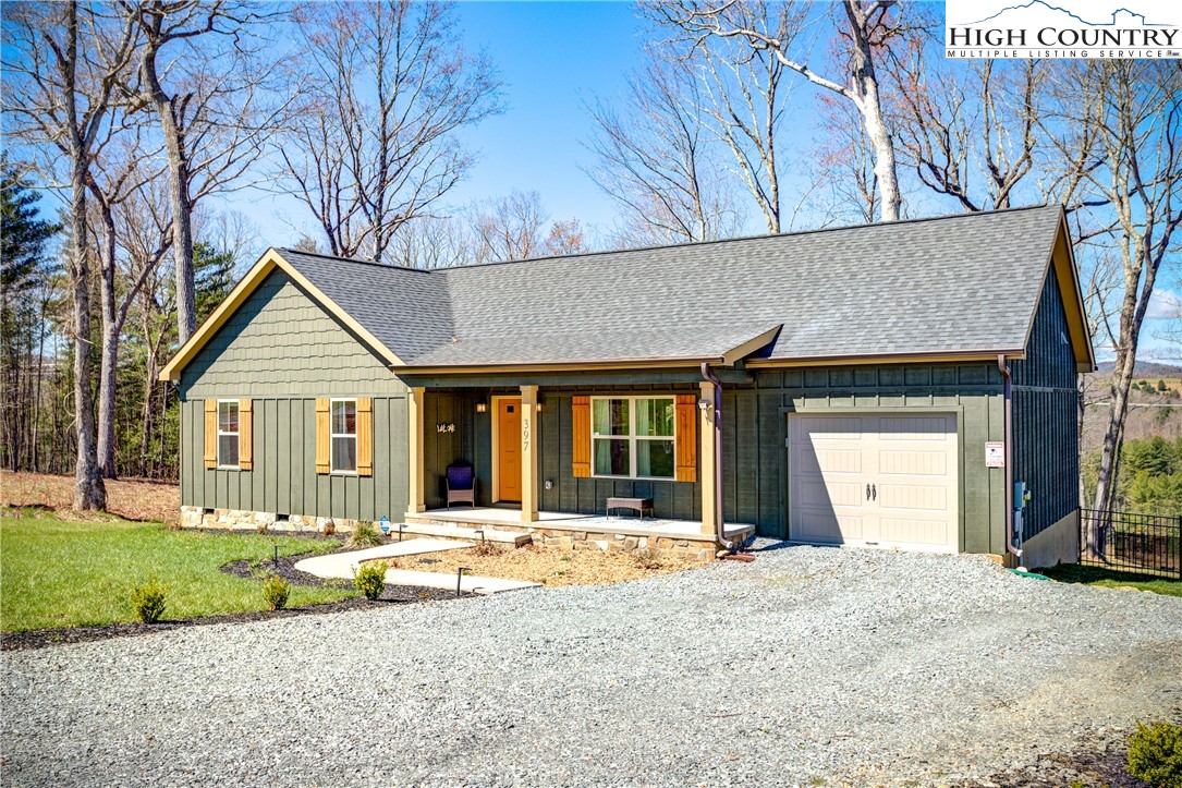 397 Turtle Ridge Road Sparta, NC 28675 - Photo 4 of 33 a front view of a house with a yard and garage