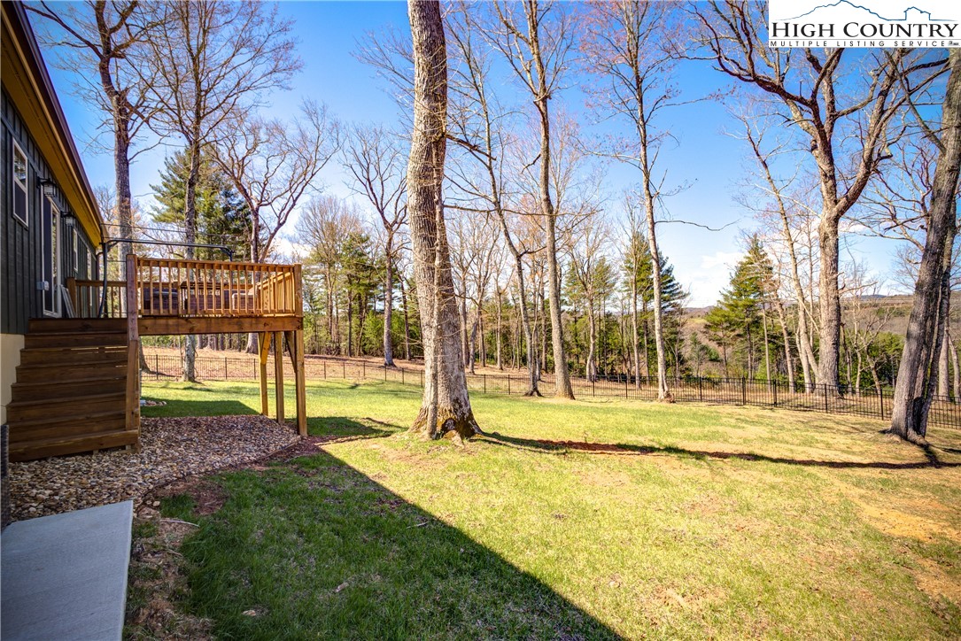 397 Turtle Ridge Road Sparta, NC 28675 - Photo 7 of 33 a view of a yard with yellow house